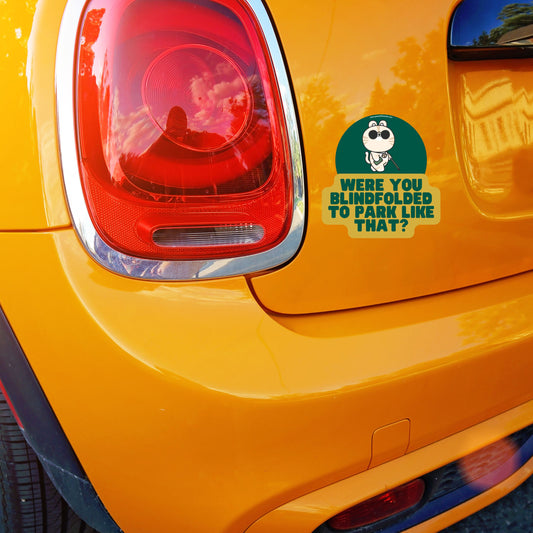 Funny car sticker with text 'Did You Use a Blindfold for That Parking Job?' on orange Mini Cooper