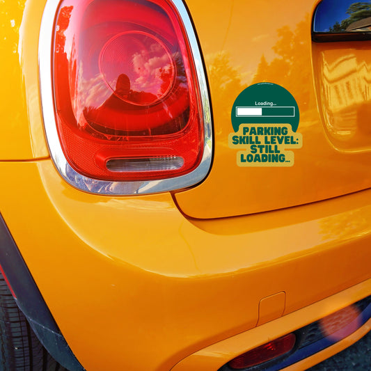 Game-themed car sticker with text 'Parking Skill Level: Still Loading...' on orange Mini Cooper