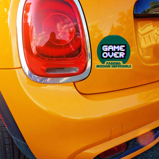 Movie-themed car sticker with text 'Parking: Mission Impossible' on orange Mini Cooper